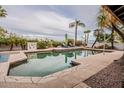 Relaxing pool area with lounge chairs, lush landscaping, and clear water for a refreshing dip at 15327 E Thistle Dr, Fountain Hills, AZ 85268