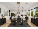 Open floor plan featuring a dining area with a modern chandelier and kitchen island at 15577 S 181St Ln, Goodyear, AZ 85338