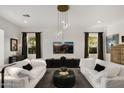 Bright living room with modern light fixture, neutral paint, and coordinated decor at 15577 S 181St Ln, Goodyear, AZ 85338