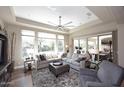 Open-concept living room with large windows, stylish furniture, and sliding glass doors at 16935 W Cambridge Ave, Goodyear, AZ 85395