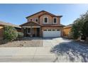 Charming two-story home showcasing meticulously landscaped front yard with low maintenance desert landscaping at 1713 W Cottonwood Ln, Phoenix, AZ 85045