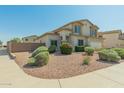 Well-maintained home with desert landscaping and a beautiful, clear blue sky at 17751 W Bloomfield Rd, Surprise, AZ 85388