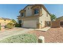 A spacious home with a two-car garage and well-kept desert landscaping at 17751 W Bloomfield Rd, Surprise, AZ 85388