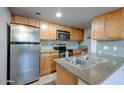 Bright kitchen with stainless steel refrigerator and microwave, and light wood cabinets at 200 E Southern Ave # 316, Tempe, AZ 85282