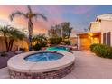 Backyard with inground hot tub and lush landscaping, ideal for unwinding at 20640 N 100Th Ln, Peoria, AZ 85382