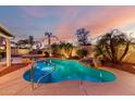 Sparkling pool with a rock waterfall and tropical landscaping for a relaxing retreat at 20640 N 100Th Ln, Peoria, AZ 85382