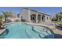 Gorgeous swimming pool with Baja step and ladder access, surrounded by a well-maintained patio at 21359 E Camacho Rd, Queen Creek, AZ 85142