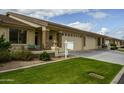 Beautiful single-story home with a well-kept lawn, stone accents, neutral paint, and spacious three-car garage at 2662 S Springwood S Blvd # 458, Mesa, AZ 85209