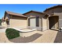 Charming home showcasing desert landscaping and hardscape elements leading to the front entrance at 3685 N 162Nd Ln, Goodyear, AZ 85395