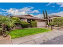 Charming single-story home featuring a beautiful front lawn, landscaping, and a two-car garage at 3881 S Marion Way, Chandler, AZ 85286