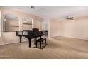 Open living room with neutral walls, plush carpeting, and archways leading to other areas at 3881 S Marion Way, Chandler, AZ 85286