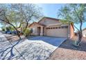 Inviting single-story home with desert landscaping, a concrete driveway, and a convenient two-car garage at 40401 W Hayden Dr, Maricopa, AZ 85138