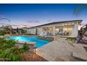 Inviting backyard oasis featuring a sparkling pool, spa, and outdoor seating area perfect for relaxation and entertaining at 4319 W Winslow Way, Eloy, AZ 85131