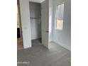 Bedroom with gray carpet and a walk-in closet adjacent to an en-suite bathroom at 43387 N Wollemi St, Queen Creek, AZ 85140