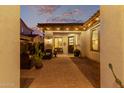 Inviting courtyard at dusk with comfortable seating, warm lighting, and tiled roof at 4376 S Santiago Way, Chandler, AZ 85248