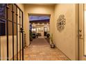 Charming courtyard with decorative wrought iron gate, brick pavers, and decorative wall art at 4376 S Santiago Way, Chandler, AZ 85248