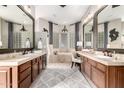 Gorgeous bathroom featuring double sinks, vanity, soaker tub and travertine tile at 4438 E Millbrae Ln, Gilbert, AZ 85234