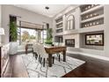 Elegant dining room featuring a fireplace, large window, and seating for six at 4438 E Millbrae Ln, Gilbert, AZ 85234