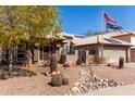 Attractive desert-landscaped home, featuring a decorative rock creek-bed and a cream-colored tile roof at 4444 W Chama Dr, Glendale, AZ 85310