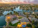 Aerial view showcasing a lakefront community with luxurious homes, pools, tennis court, and beautifully landscaped yards at 479 E Horseshoe Pl, Chandler, AZ 85249