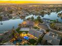 Stunning aerial view of a lakeside community featuring upscale homes, private pools, and lush landscaping at sunset at 479 E Horseshoe Pl, Chandler, AZ 85249