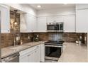 Close-up of a well-appointed kitchen showcasing stainless steel appliances and tiled backsplash at 4800 N 68Th St # 109, Scottsdale, AZ 85251