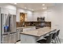 Modern kitchen featuring stainless steel appliances, granite countertops, and stylish pendant lighting at 4800 N 68Th St # 109, Scottsdale, AZ 85251