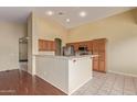 Open-concept kitchen featuring ample cabinetry, stainless steel appliances, and a peninsula overlooking the adjacent living area at 4806 E Thunderbird Dr, Chandler, AZ 85249