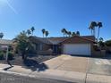 Well-maintained single-story home with desert landscaping, a two-car garage, and clear blue skies at 4807 E Everett Dr, Scottsdale, AZ 85254