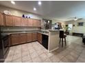 Well-lit kitchen with granite countertops, tile flooring, and dark appliances at 4939 W Harwell Rd, Laveen, AZ 85339