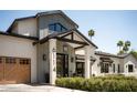 Beautiful home featuring a covered front porch, manicured bushes and stone address numbers at 6114 E Calle Del Norte --, Scottsdale, AZ 85251