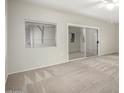 Living room showcasing a large sliding glass door to the balcony and a pass-through window at 9455 E Raintree Dr # 1049, Scottsdale, AZ 85260