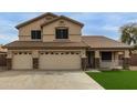 Two-story home featuring a three-car garage and a charming front porch at 9627 W Reno View Dr, Peoria, AZ 85345