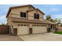 Two-story home featuring a three-car garage, desert landscaping, and a tiled roof at 9627 W Reno View Dr, Peoria, AZ 85345