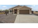 Charming single-story home with desert landscaping, a two-car garage and concrete driveway at 9965 W Devonshire Dr, Arizona City, AZ 85123