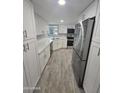 Bright kitchen featuring white cabinets, stainless steel appliances, and light countertops at 10328 E Michigan Ave, Sun Lakes, AZ 85248