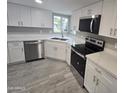 Bright kitchen featuring white cabinets, stainless steel appliances, and light countertops at 10328 E Michigan Ave, Sun Lakes, AZ 85248