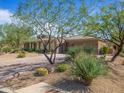 Attractive home with desert landscaping, multiple car garage, and a circular driveway at 10829 E Volterra Ct, Scottsdale, AZ 85262