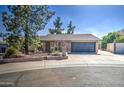 Charming single-story home with a two-car garage and mature landscaping at 1205 W El Prado Rd, Chandler, AZ 85224