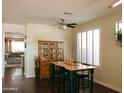 Charming dining area featuring hardwood floors, a vintage hutch, and bright natural light, perfect for Gathering meals at 13216 S 175 Dr, Goodyear, AZ 85338