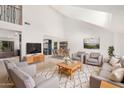 Spacious living room is styled with modern furniture, wood flooring, and natural light at 13244 N 54Th Dr, Glendale, AZ 85304