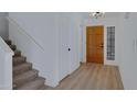 Entryway boasting wood floors, neutral tones, and access to a carpeted staircase at 13824 S 41St Way, Phoenix, AZ 85044