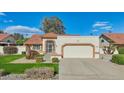 Charming single-story home with a tile roof, well-maintained lawn, desert landscaping and driveway at 13942 W Summerstar Dr, Sun City West, AZ 85375