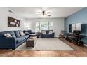 Bright living room featuring couches, fan, large window, tile flooring and plenty of natural light at 14042 N 44Th St, Phoenix, AZ 85032