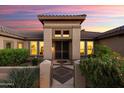 Inviting front entrance with beautiful desert landscaping and a covered entryway at 16253 W Windcrest Dr, Surprise, AZ 85374