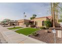 Lovely single-story home featuring desert landscaping, a red tile roof, and an attached two-car garage at 2450 W Keating Ave, Mesa, AZ 85202