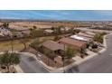 Aerial view of a residential neighborhood showcasing well-maintained homes, green spaces, and scenic mountain views at 25067 W Dove Trl, Buckeye, AZ 85326