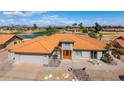 Stunning aerial view of a property situated on a golf course, boasting a vibrant tiled roof and desert landscape at 2585 Leisure World --, Mesa, AZ 85206