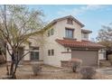 Lovely two-story home featuring a red tile roof, stucco siding, and a tidy landscape at 25872 W Hilton Ave, Buckeye, AZ 85326