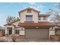 Attractive two-story house with a red tile roof and neutral stucco exterior at 25872 W Hilton Ave, Buckeye, AZ 85326